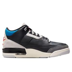 A black, gray, and white sneaker with blue accents and red detailing, featuring a visible air unit in the sole and a mid-top design.