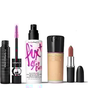 The 4-piece MAC Makeup Set includes a black MAC Stack mascara with a pink brush, a Fix+ Stay Over setting spray, a Studio Radiance foundation, and a bullet-shaped lipstick in a nude shade.