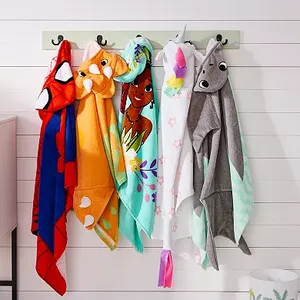 Kids' animal-themed hooded towels hung on wall hooks.