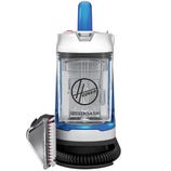 A Hoover PowerDash portable carpet cleaner with a transparent water tank, blue handle, and an attached hose featuring a cleaning brush.