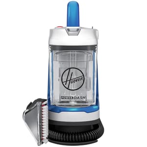 A Hoover PowerDash portable carpet cleaner with a transparent water tank, blue handle, and an attached hose featuring a cleaning brush.