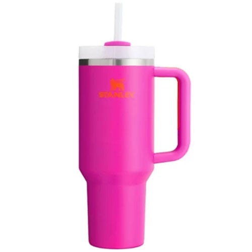 A pink travel mug with a handle and straw, featuring the brand Stanley on its side.