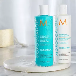 Two bottles of Moroccanoil Hydration: a turquoise Hydrating Shampoo and a white Hydrating Conditioner, each 8.5 fl oz/250 ml, suitable for all hair types and free from sulfates, phosphates, and parabens.