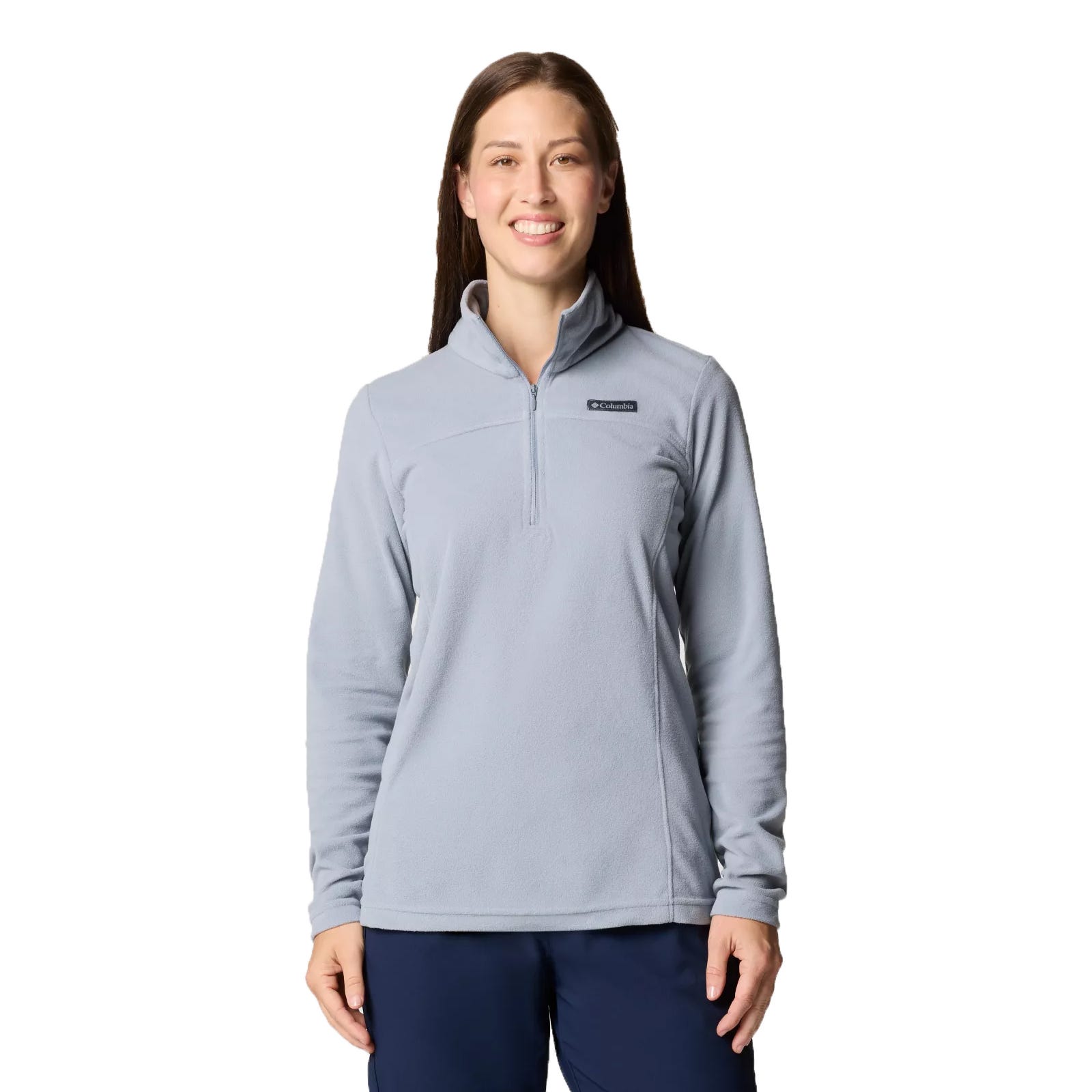 A woman is wearing a light blue Columbia half-zip fleece pullover and navy pants, standing against a white background.