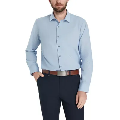 A man is wearing a light blue button-up shirt with long sleeves, paired with dark trousers and a brown belt.