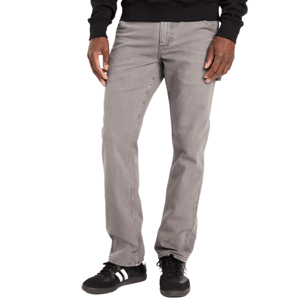 Gray jeans paired with a black sweatshirt and black sneakers with white stripes.