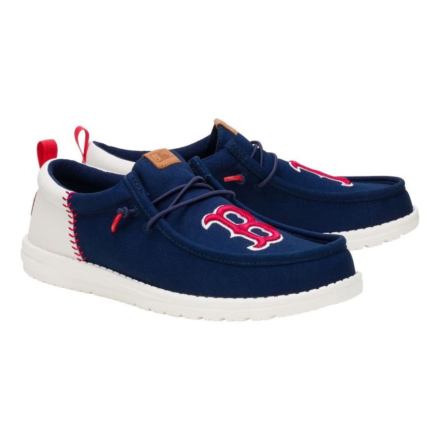 Navy blue slip-on shoes featuring a red and white logo on the toe, complemented by white soles and red accents.