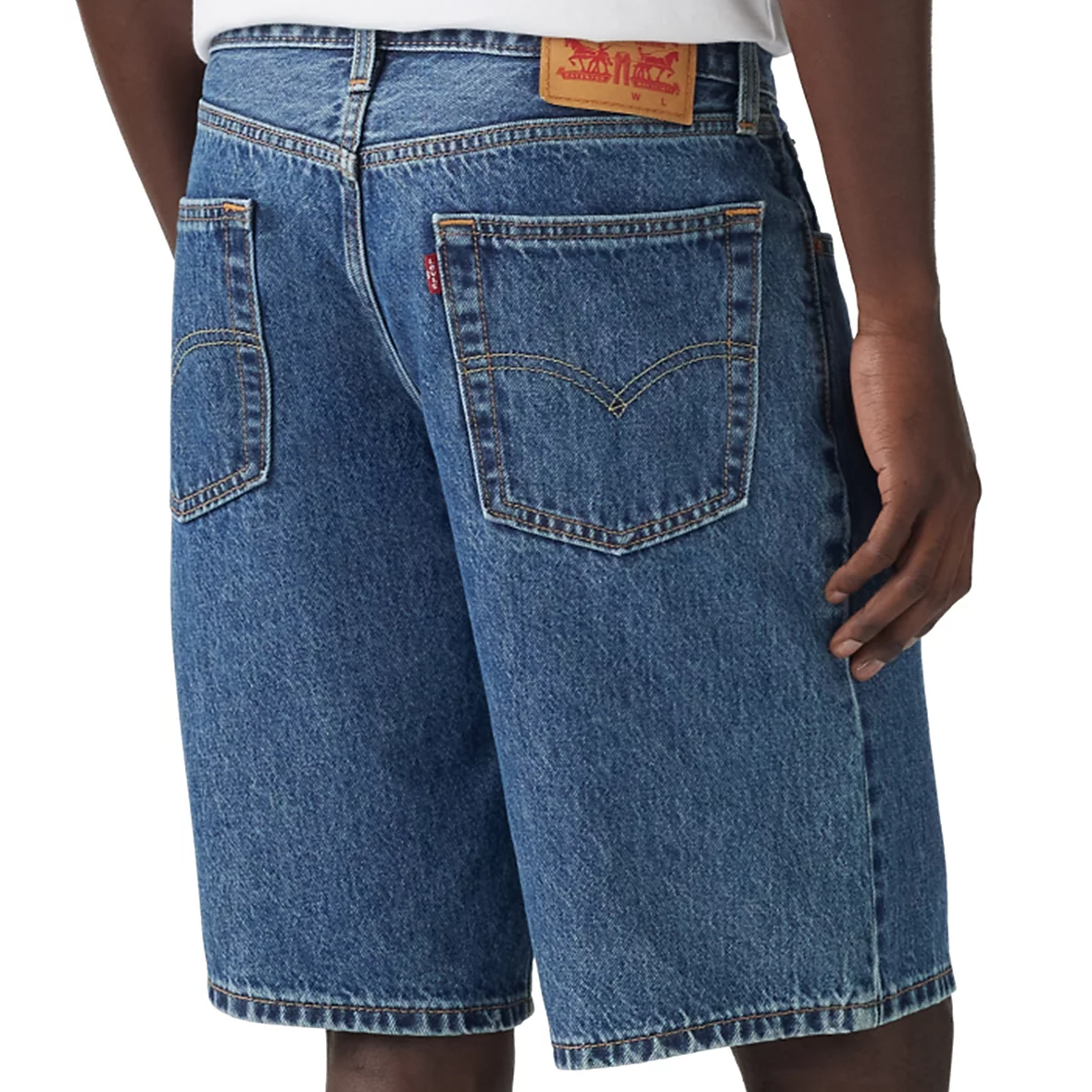 Levi's Men's Relaxed-Fit Denim Shorts feature a classic blue denim design with a relaxed fit, falling to knee-length. They include traditional back pockets with distinctive stitching and a leather logo patch on the waistband.