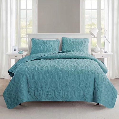 A teal-teal colored quilt set on a Queen bed.