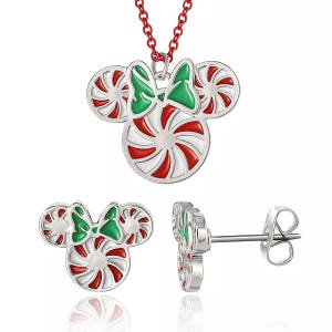A festive Minnie Mouse jewelry set featuring a necklace and earrings with red and white peppermint swirl design, accented with green bows, and made of stainless steel.