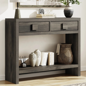 Dark wood console table with two drawers, displaying decorative vases, books, a wicker basket, and a small clock.