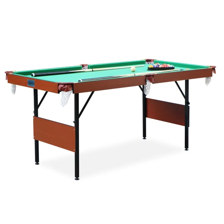 A compact, foldable pool table with a green playing surface, brown sides, and black legs, featuring drop pockets and equipped with cues and balls.