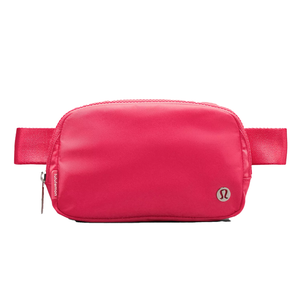 A bright pink Lululemon belt bag with a sleek design, featuring a zipper compartment, adjustable strap, and the Lululemon logo.