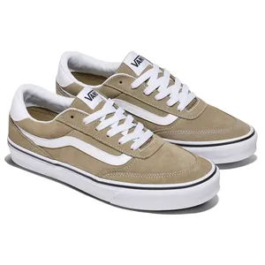 Tan suede Vans sneakers with white laces and a white stripe on the side, featuring a white rubber sole with a black accent line.