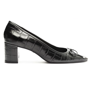 Schutz Arissa Pumps are black, croc-embossed leather shoes featuring a rounded toe and a block heel, adorned with a small bow detail on top.