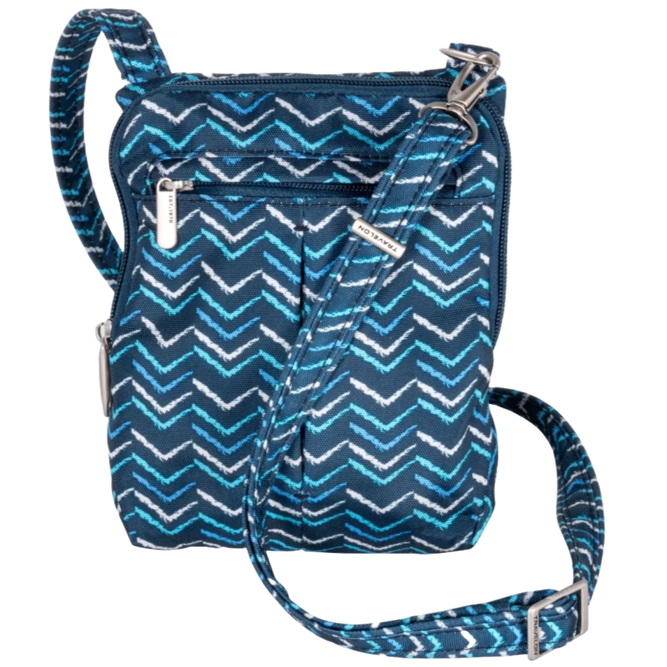 The Travelon Anti-Theft Slim Pouch features a blue chevron pattern with white and light blue accents, a zippered pocket, and an adjustable strap.