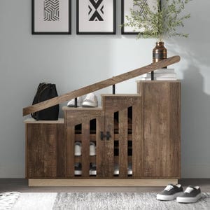 A tiered shoe storage cabinet with a wooden finish, it features open shelves on one side and a closed cupboard on the other, with a flat top for additional storage or display.