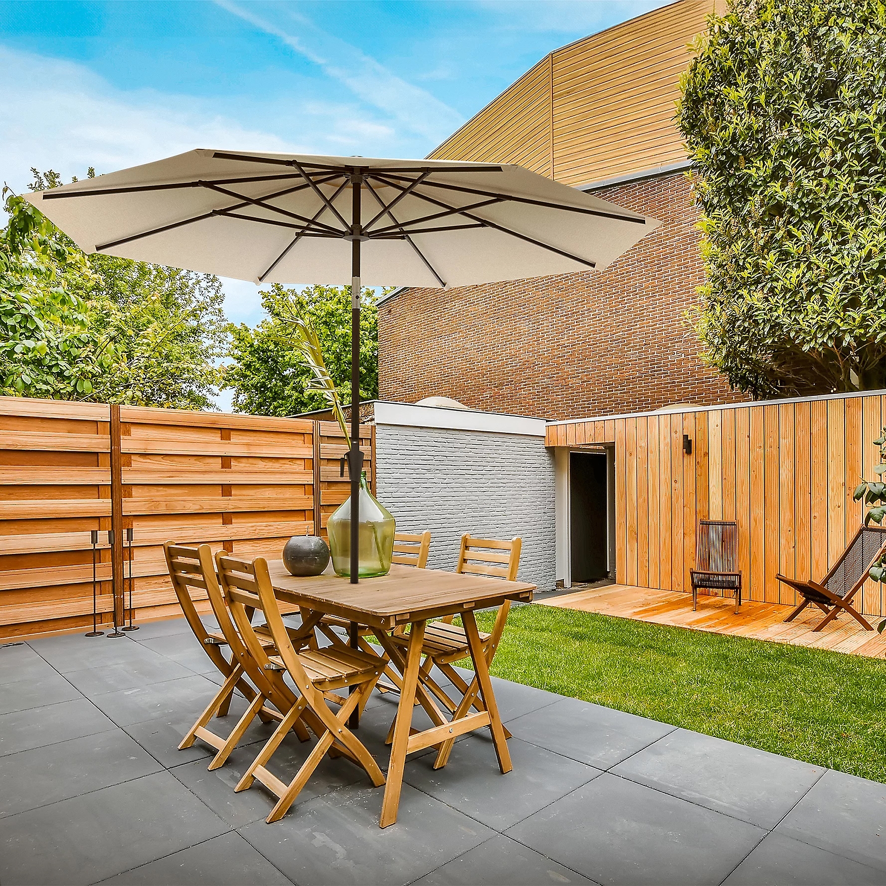 9' patio umbrella with a round beige canopy and dark wooden frame, providing shade over a wooden outdoor dining set on a tiled patio.