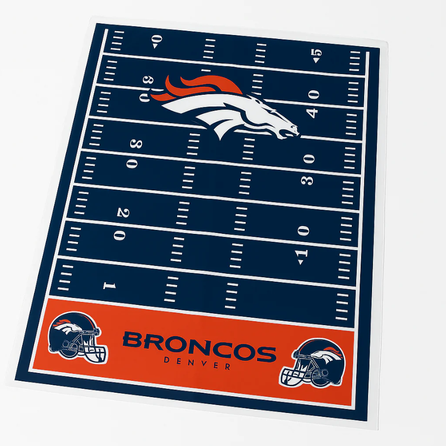 Denver Broncos-themed rug featuring a football field design, with the Broncos logo prominently displayed at midfield and team helmets at the ends.