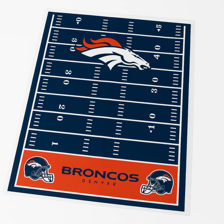 Denver Broncos-themed rug featuring a football field design, with the Broncos logo prominently displayed at midfield and team helmets at the ends.