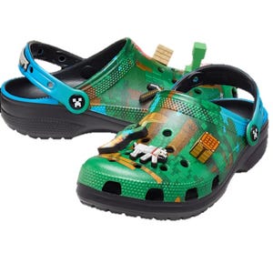 Brightly colored clogs with a green pixelated design inspired by a popular video game, featuring character charms and a cool blue strap.