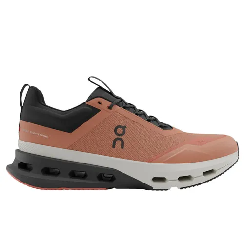 A coral-colored athletic shoe with black and white accents featuring a cushioned sole and a logo on the side.
