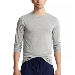 A person is wearing a light gray long-sleeve shirt with a small logo near the hem and navy blue drawstring pants.