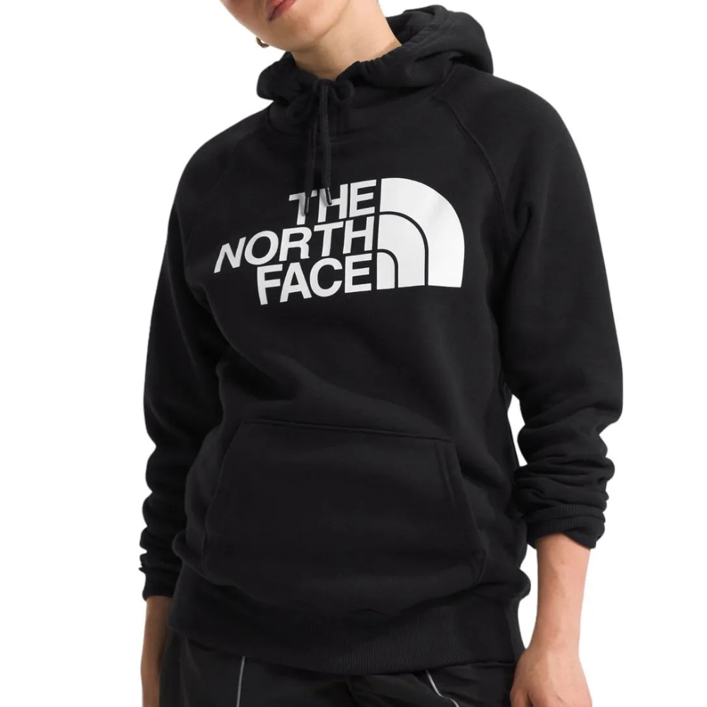 A person is wearing a black hoodie with \“The North Face\“ logo prominently displayed on the front. The hoodie features a drawstring hood and a front kangaroo pocket.
