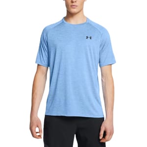 A man wearing a light blue Under Armour short-sleeve athletic shirt with the logo on the chest, paired with black shorts.