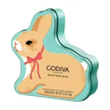 Godiva Masterpiece chocolates in a bunny-shaped tin, crafted in the USA with global ingredients. Net weight: 5.1 oz (144g).