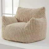 A beige, ribbed corduroy bean bag chair with armrests and backrest, designed for comfort and casual seating.