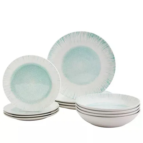 A set of dinnerware featuring plates and bowls with a white and light turquoise design, having a textured center and radial lines on the edges.