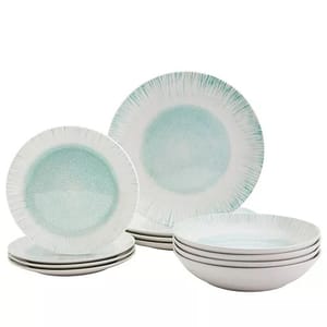 A set of dinnerware featuring plates and bowls with a white and light turquoise design, having a textured center and radial lines on the edges.