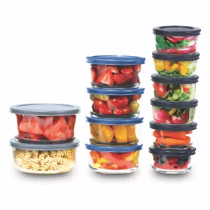 A collection of transparent containers with blue lids, stacked and filled with various foods like fruits, vegetables, and pasta.