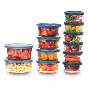 A collection of transparent containers with blue lids, stacked and filled with various foods like fruits, vegetables, and pasta.