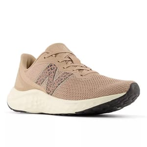A beige athletic shoe with a mesh upper and a leopard-patterned \“N\“ logo, featuring a cushioned, textured white sole and a black outsole.