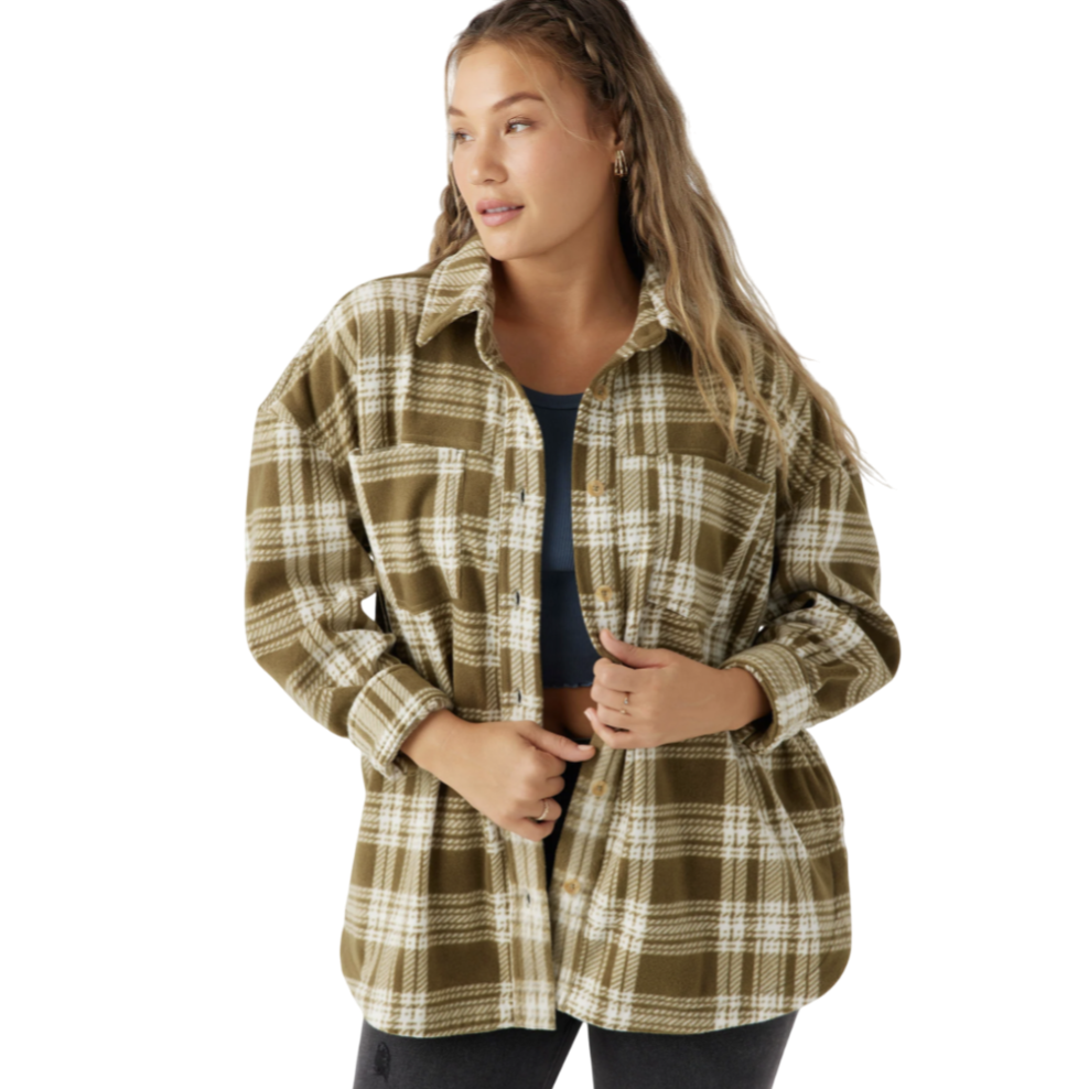 A person is wearing a brown and white plaid flannel shirt over a dark top, paired with ripped black jeans.