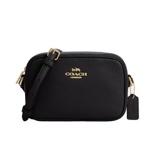 A black leather Coach crossbody bag with gold hardware and an adjustable strap, featuring the Coach logo on the front.