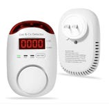 Gas and carbon monoxide detector with LED display showing 0000, featuring labeled indicators for power, fault, and alarm, and a self-test button. The back includes plug connectors and model information.