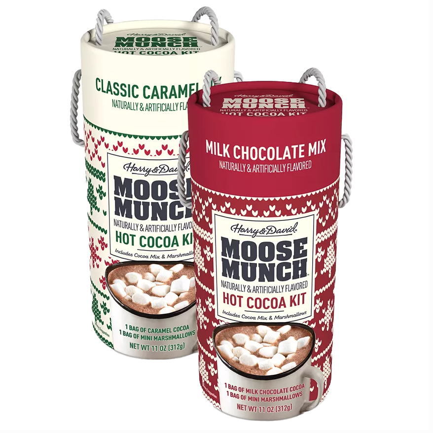 Two Harry & David Moose Munch Hot Cocoa Kits, one Classic Caramel and one Milk Chocolate Mix. Each kit includes a cocoa mix and a bag of mini marshmallows, with a net weight of 11 oz (312 g) per kit, packaged in festive cylindrical containers.