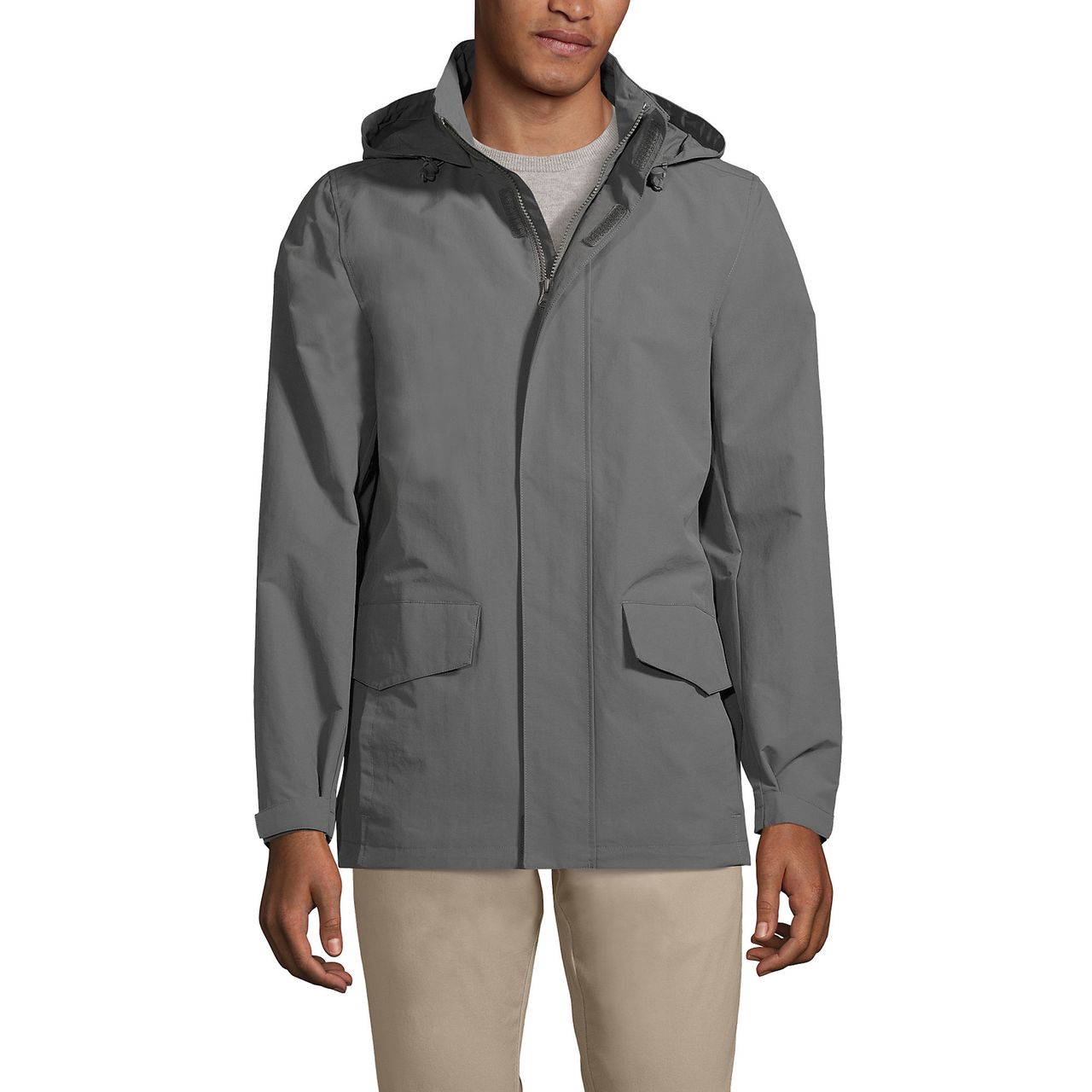 A man is wearing a gray Lands' End Outrigger Jacket with a hood, zip front, and two large flap pockets.