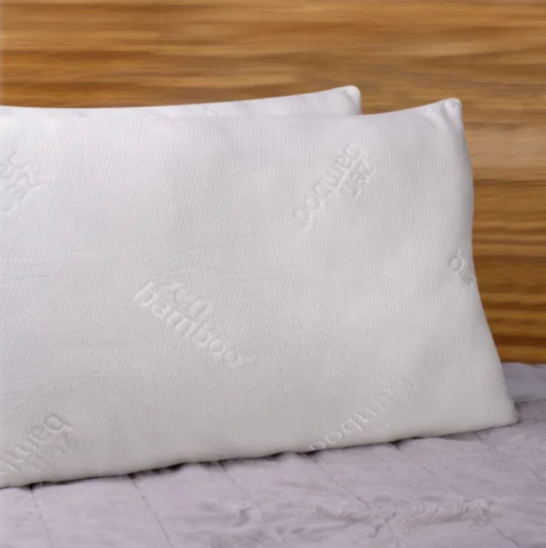 Two white queen-sized pillows with a bamboo imprint are positioned on a bed, featuring cooling gel technology for comfort.