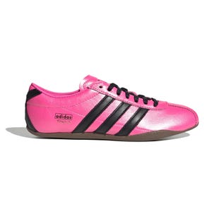 Bright pink Adidas Tokyo shoe with black stripes, featuring a sleek design and low profile.