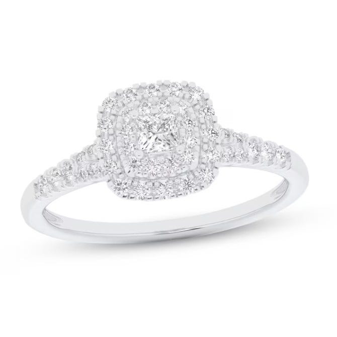 Diamond engagement ring with a square halo design, featuring a cushion-cut center stone and a band adorned with smaller diamonds.
