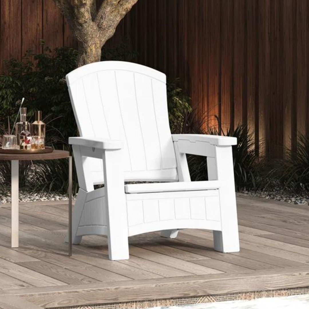 White Adirondack chair on a wooden deck with a small round table holding a tray with bottles.