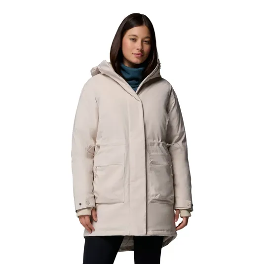 A woman is wearing a light beige, hooded parka with two large front pockets and adjustable drawstrings at the waist.