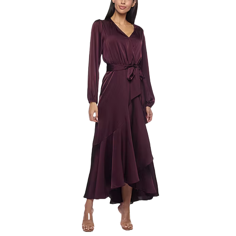 Long-sleeve, V-neck wrap dress in dark burgundy with a tie waist and asymmetrical hemline, paired with nude heels.