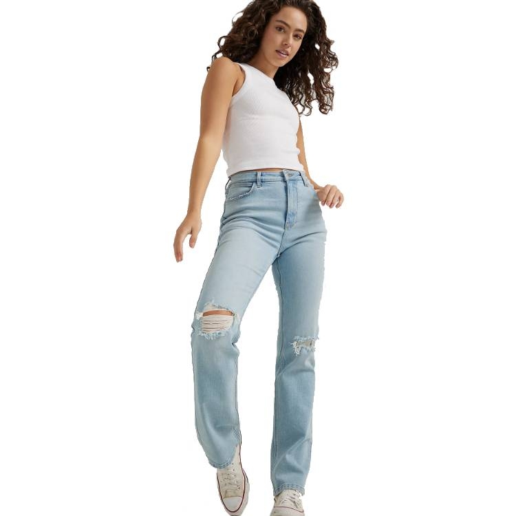 High-rise, light blue Wrangler jeans with a straight leg, distressed detailing on the knees, worn with a white tank top and white sneakers.