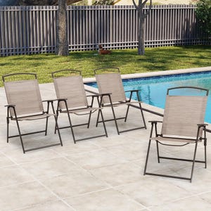 Four outdoor folding armchairs with metal frames and beige-textured sling seats are arranged on a patio by a pool. Each chair features armrests and a simple, modern design.
