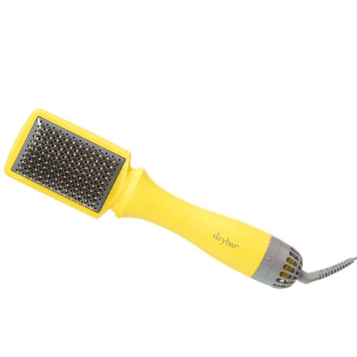 A yellow and gray heated styling brush with a paddle-shaped design, featuring bristles and a cord.